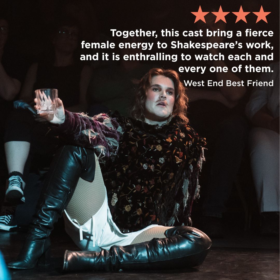 a performer in knee-high leather boots sits on the floor holding a glass with an audience sat behind them - The Taming of the "Shrew" by HER Production, The Dukes Lancaster