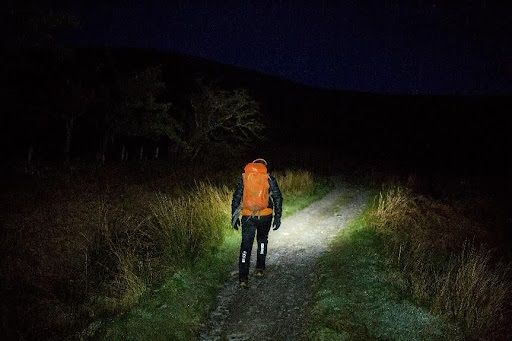 Julie Fellrunning in the dark with a large bag on her back