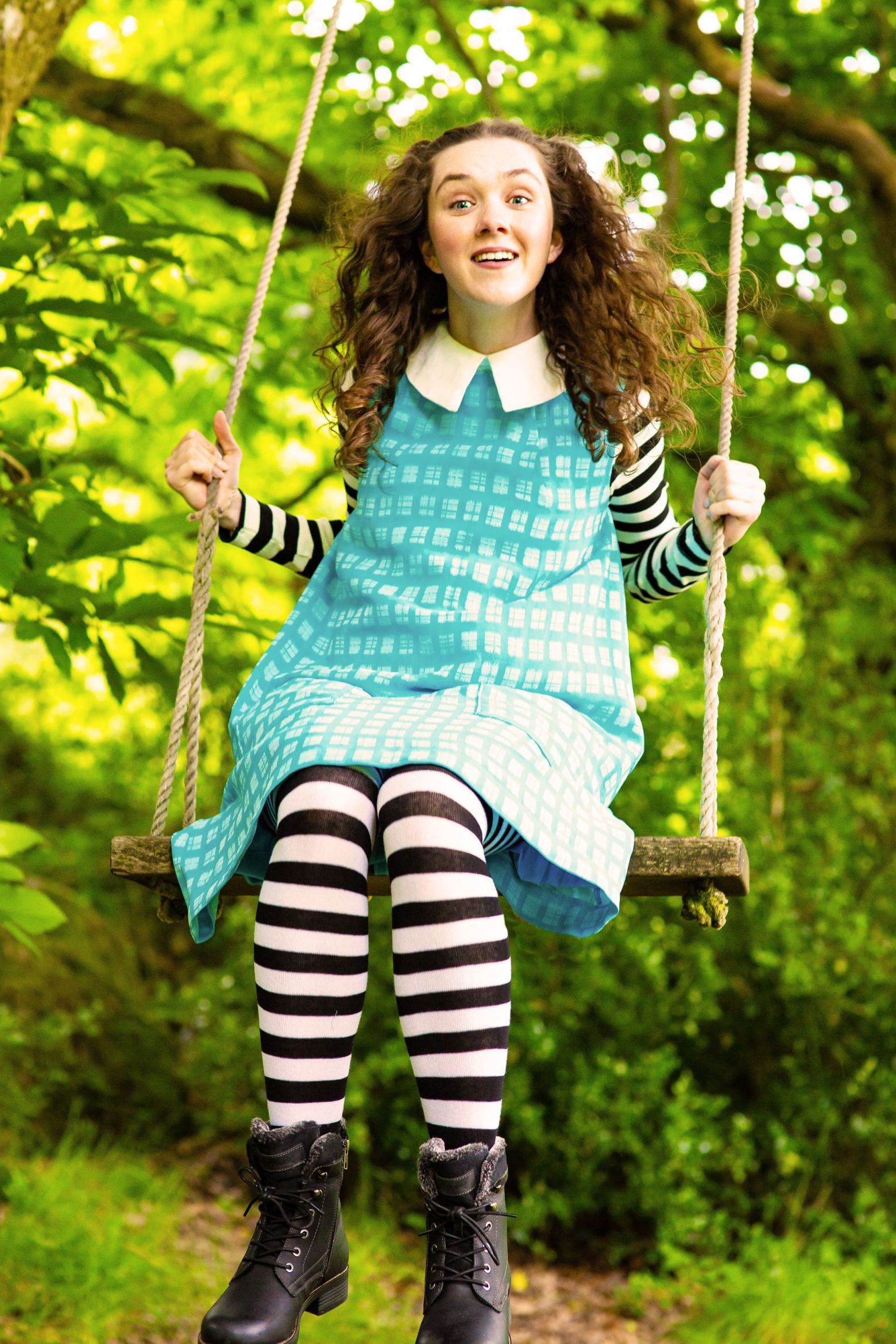 Alice in Wonderland at the Dukes. Alice on a swing in the woods.