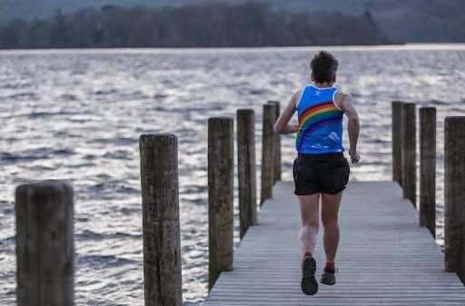 Julie Fellrunning down a wooden jetty over a lake