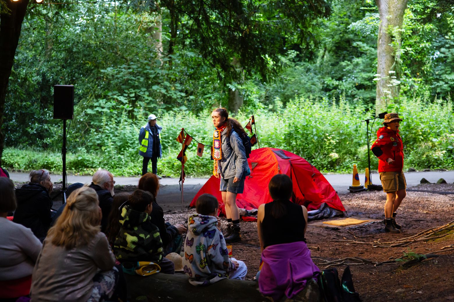 Alice in Wonderland at the Dukes. Alice speaking to audience in the oodland at Williamson Park in opening scene.