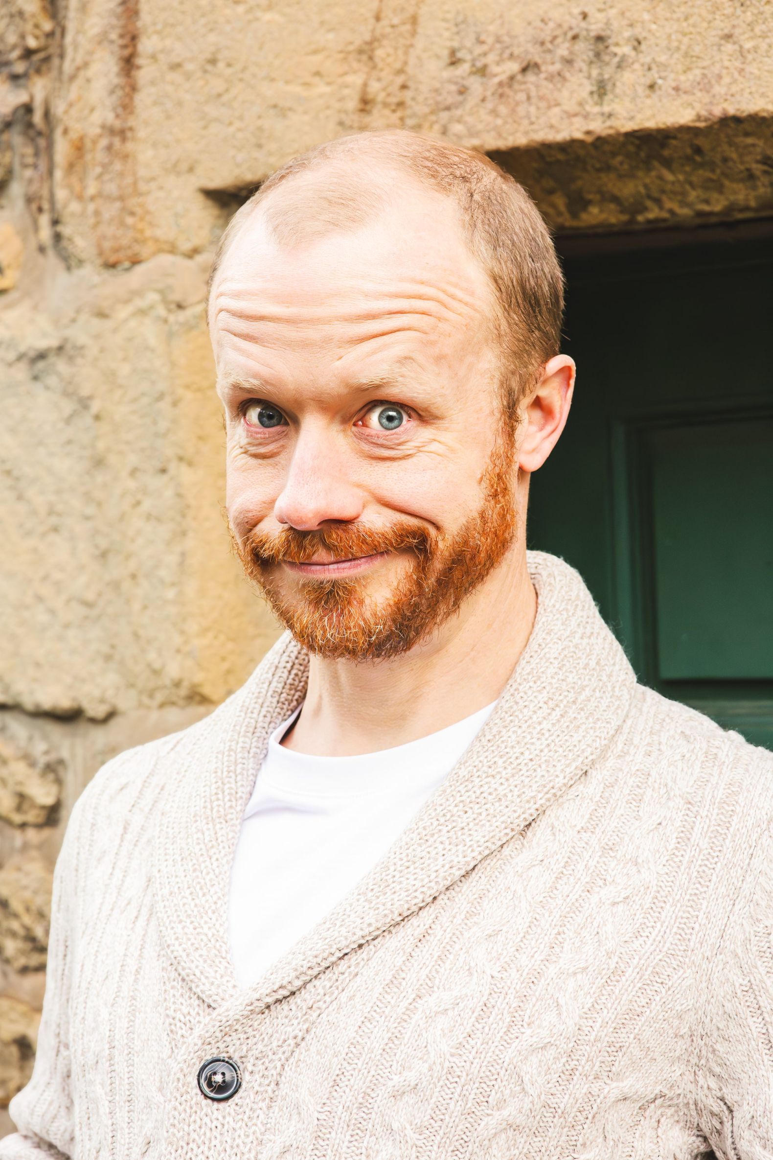 The Snow Queen at the Dukes - Mr Buckler looks to camera smiling, he is wearing a sandy coloured cardigan and while shirt.