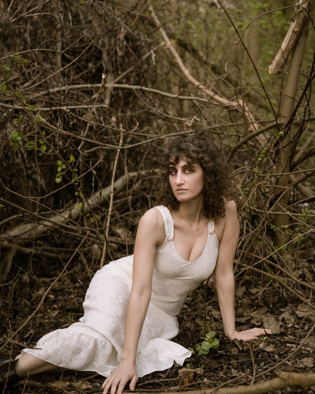 performer sat in forest in a white dress - Macbeth by HER Productions at The Dukes, Lancaster