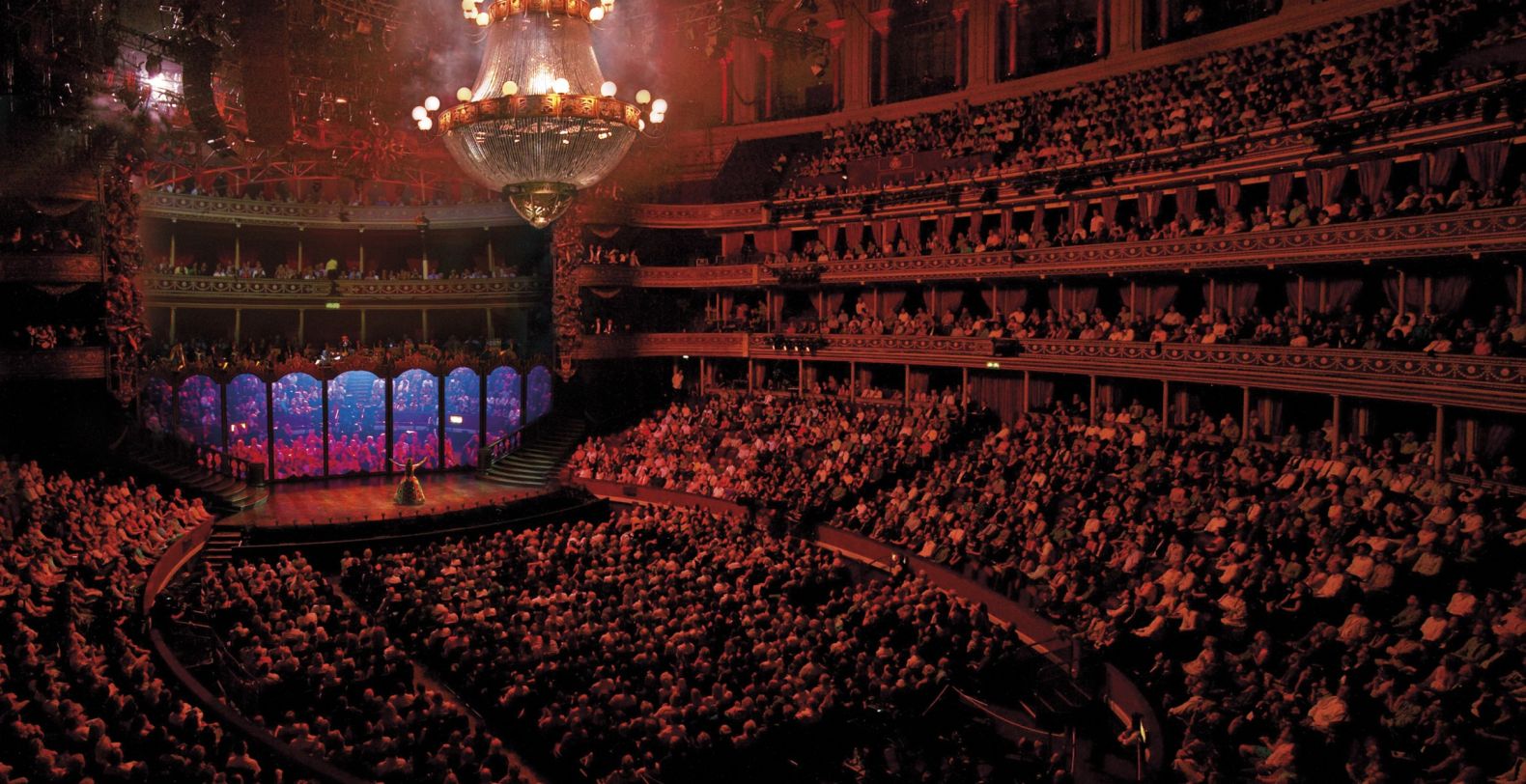 A wide photograph showing a full aditorium, looking towards the stage 