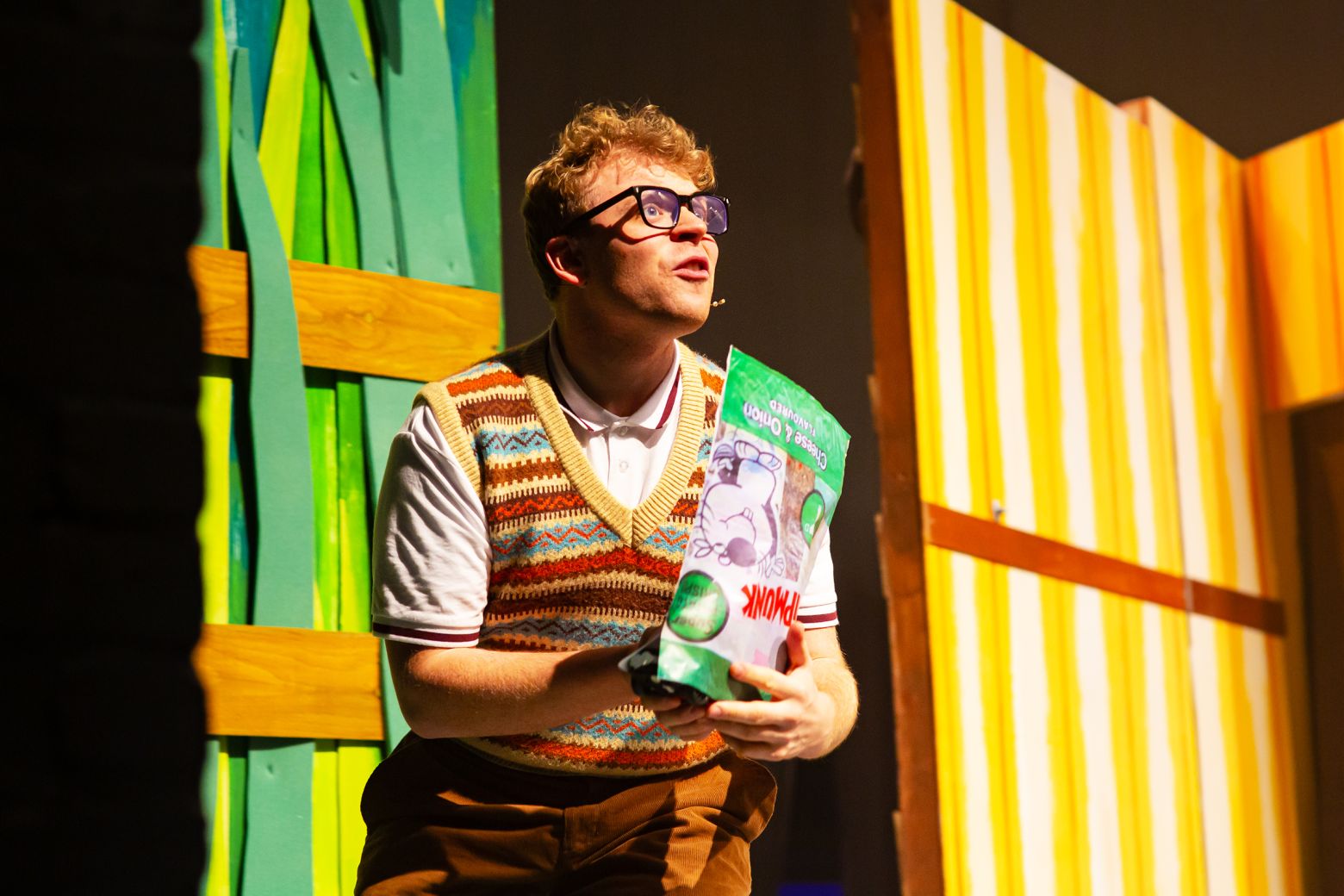 Young Eddie holding a packet of crisps. The Borrowers by the Dukes, photo by Gabi Dawkins