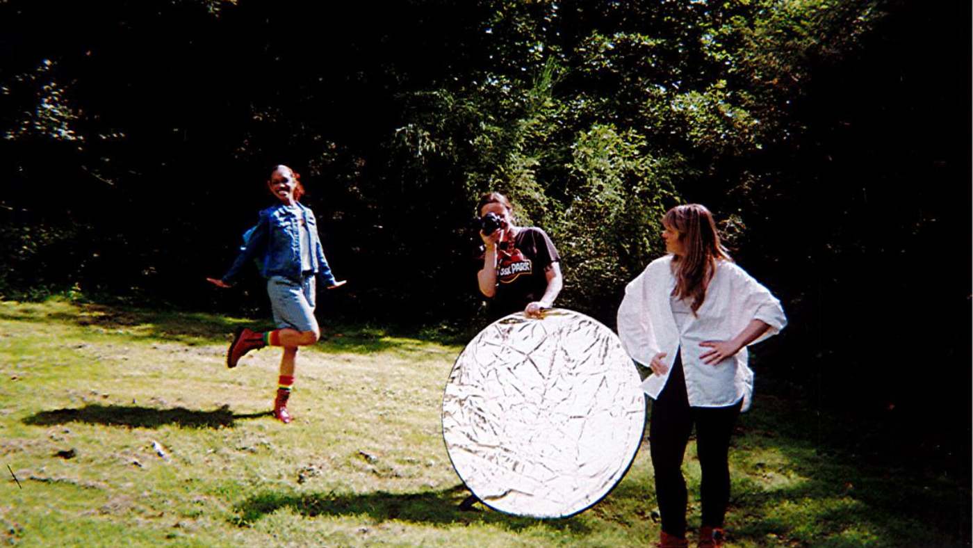 From the left. Hope Yoland as Dorothy, posing with her arms by her side and one leg bent, Gabi Dawkins pointing her camera and holding the reflective disk and Elvi Piper with her arms on her hip, looking at Hope.Photo taken by The Wizard of Oz Team. 