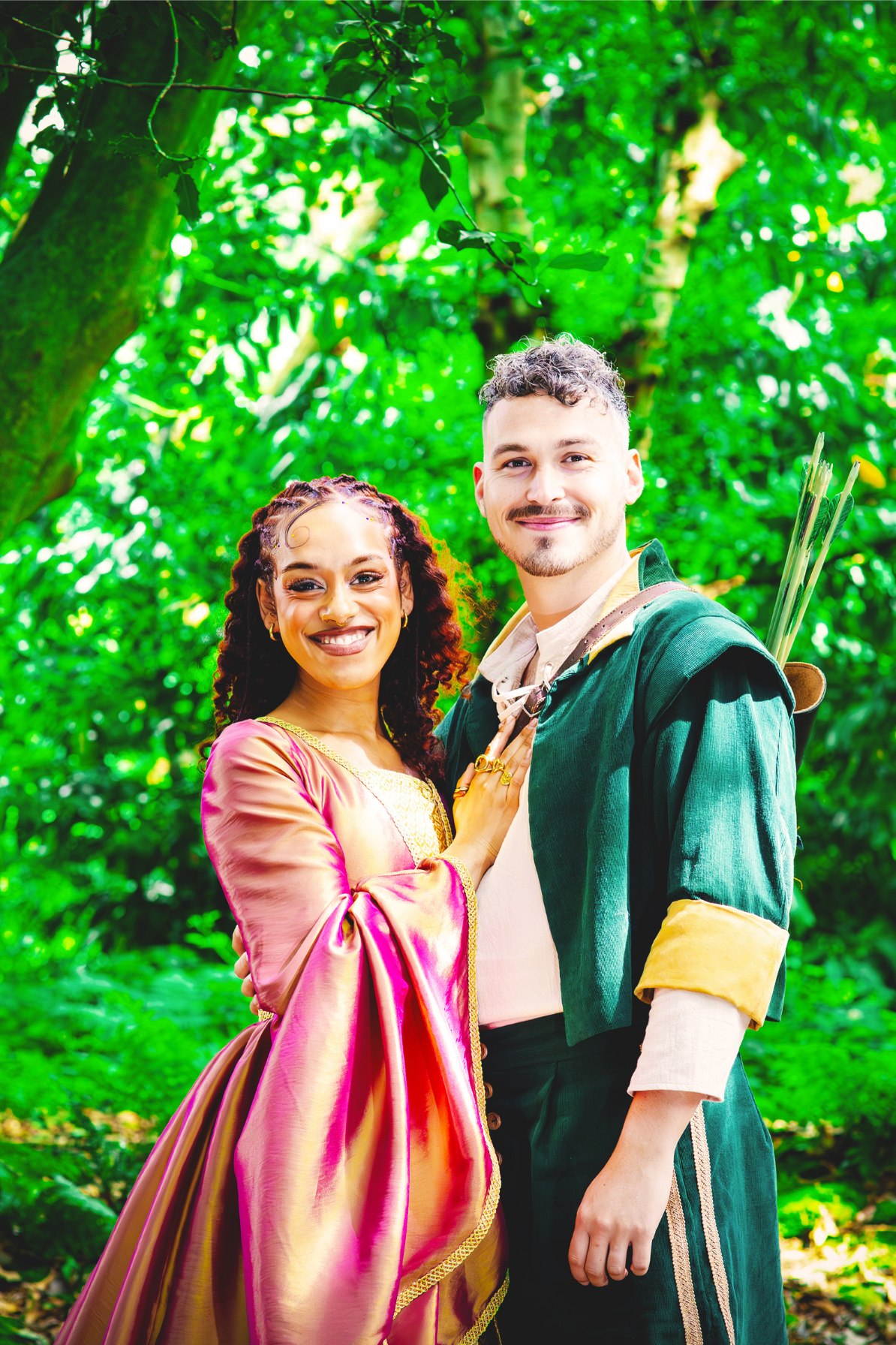 Marian and Rob smile at the camera, surrounded by the greenery of the park