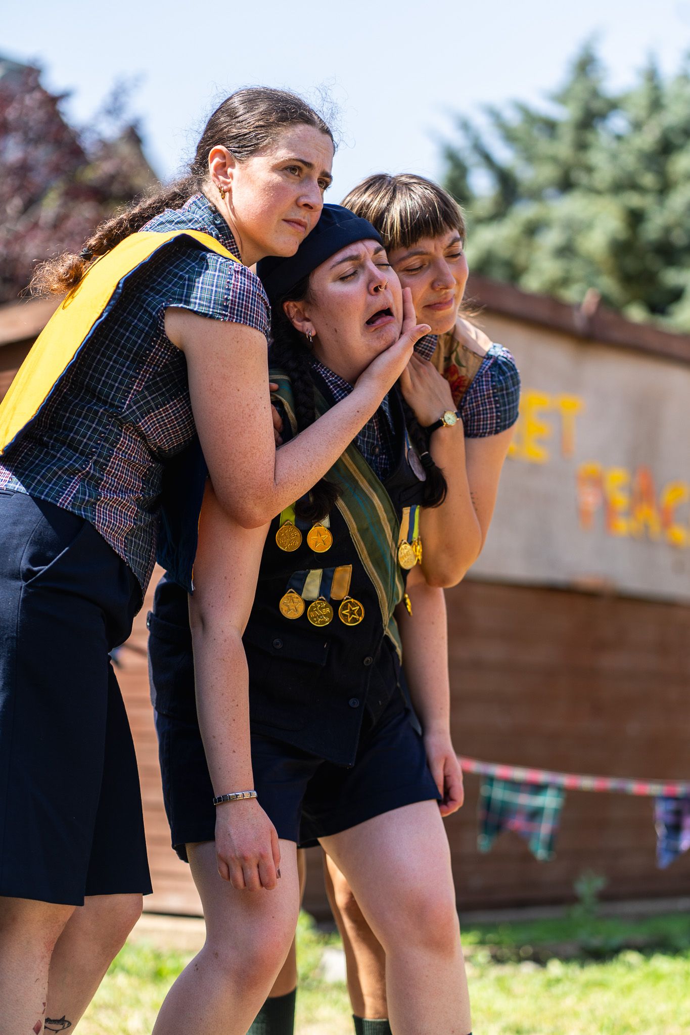 The Handlebards cast in the show. Two cast members hold up a crying cast member.