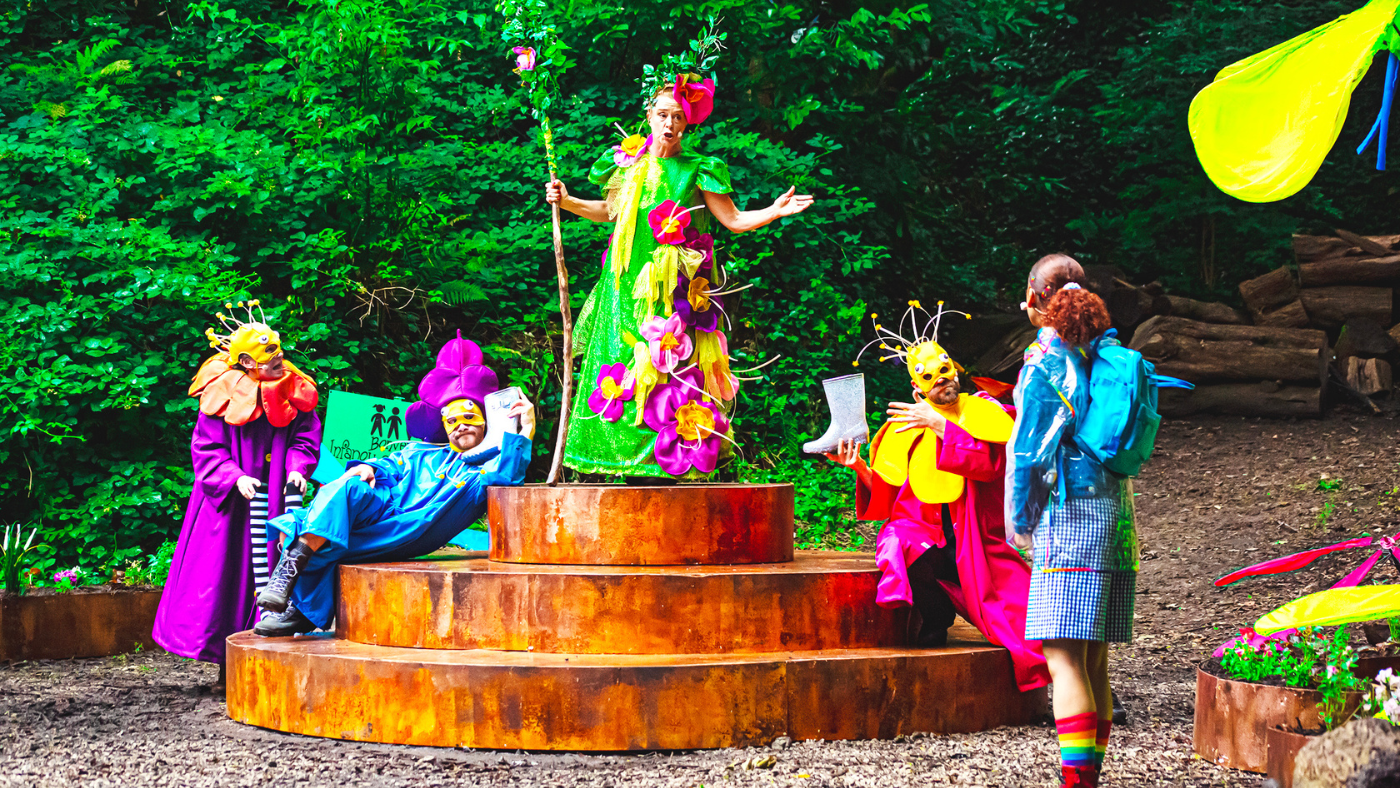 The Good Witch (Lisa Howard) surrounded by Munchkins (Helen Longworth, Gareth Cassidy and Matthew Ganley), talking to Dorothy (Hope Yolanda). The Wizard of Oz by the Dukes, photos by Gabi Dawkins.