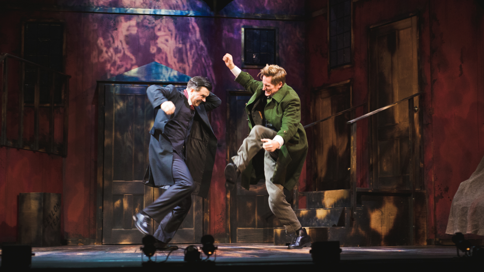 Two men jump in the air opposite each other.