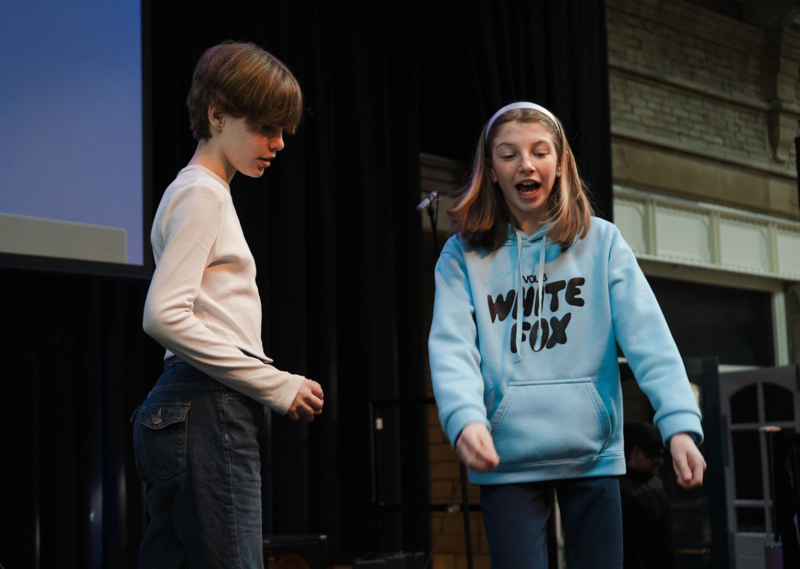 a young boy and girl acting something