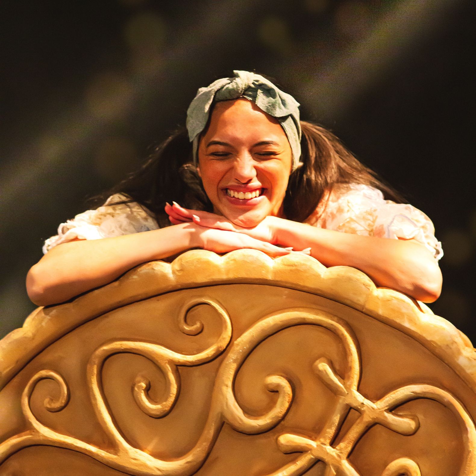 Image of Arrietty leaning on a large Jammie Dodger