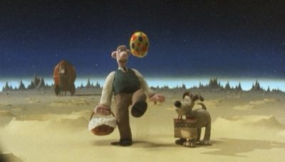 Wallace and Gomit on the moon.  Both are carrying picnic baskets and Wallace is kicking a ball.