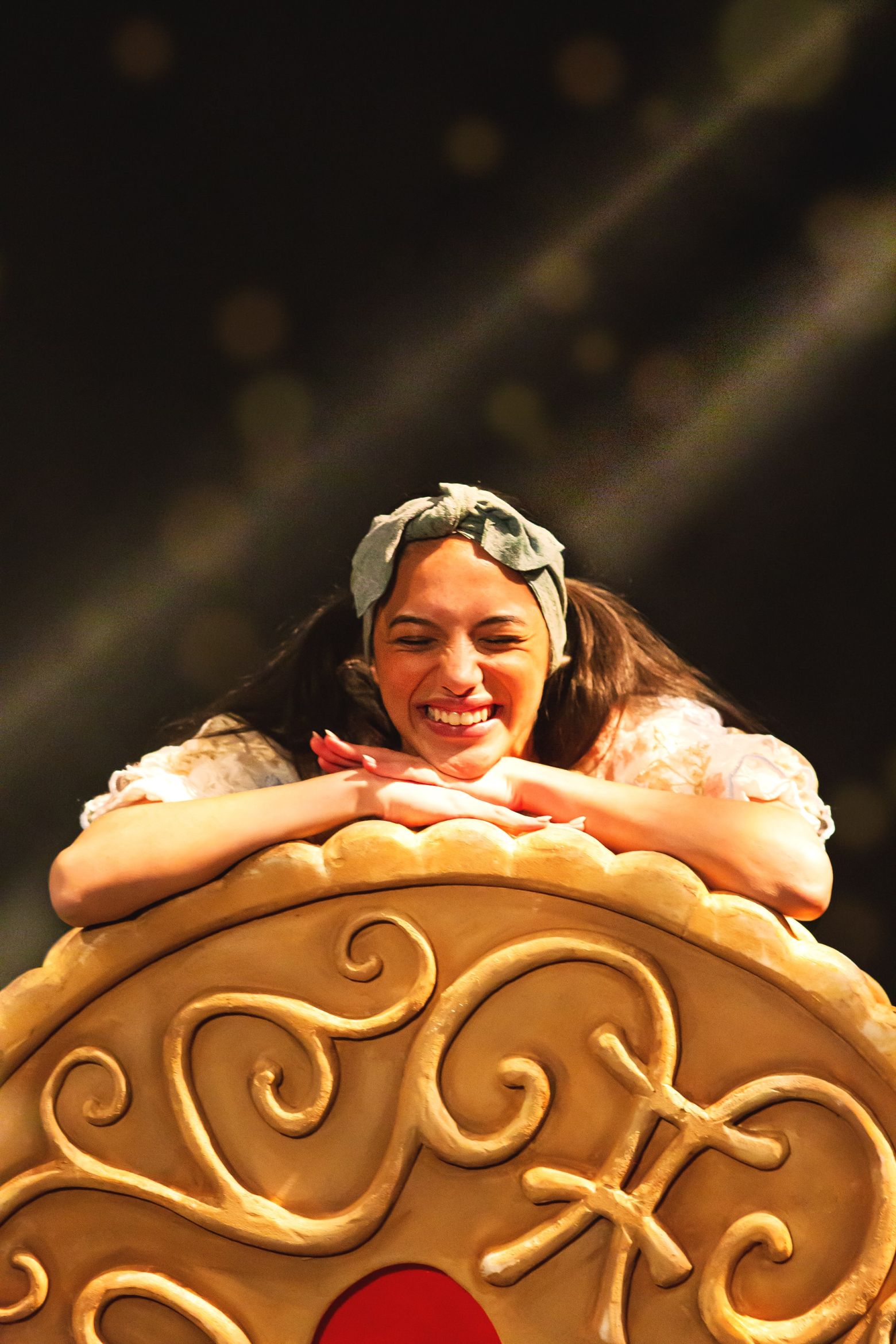 Arrietty leaning on giant jammy dodger. The Borrowers by the Dukes, photo by Gabi Dawkins.