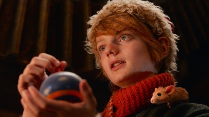 A Boy Called Christmas Film Still: Nikolas holding a wooden top while loyal pet mouse Miika sits on his shoulder.