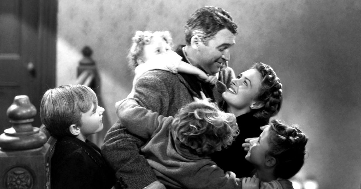 It's a Wonderful Life Film Still: George Bailey (James Stewart) surrounded by his wife Mary (Donna Reed) and children.