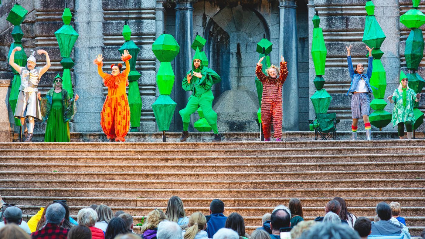 At the Ashton Memorial, Tinman, Lion, Scarecrow, Dorothy with their arms up. The Oz Guard standing in the middle, clapping, and two Community Cast members dancing behind everyone. The Wizard of Oz by the Dukes, photos by Gabi Dawkins.