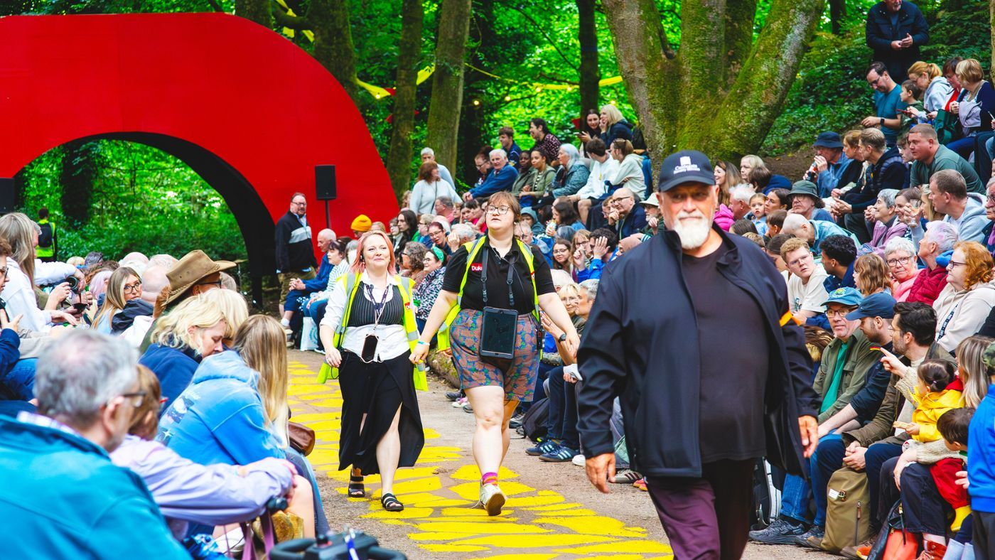 Caroline Scott and Sueda Baxter walking along the yellow brick road, in their yellow hi-vis jackets. The Wizard of Oz by the Dukes, photos by Gabi Dawkins.