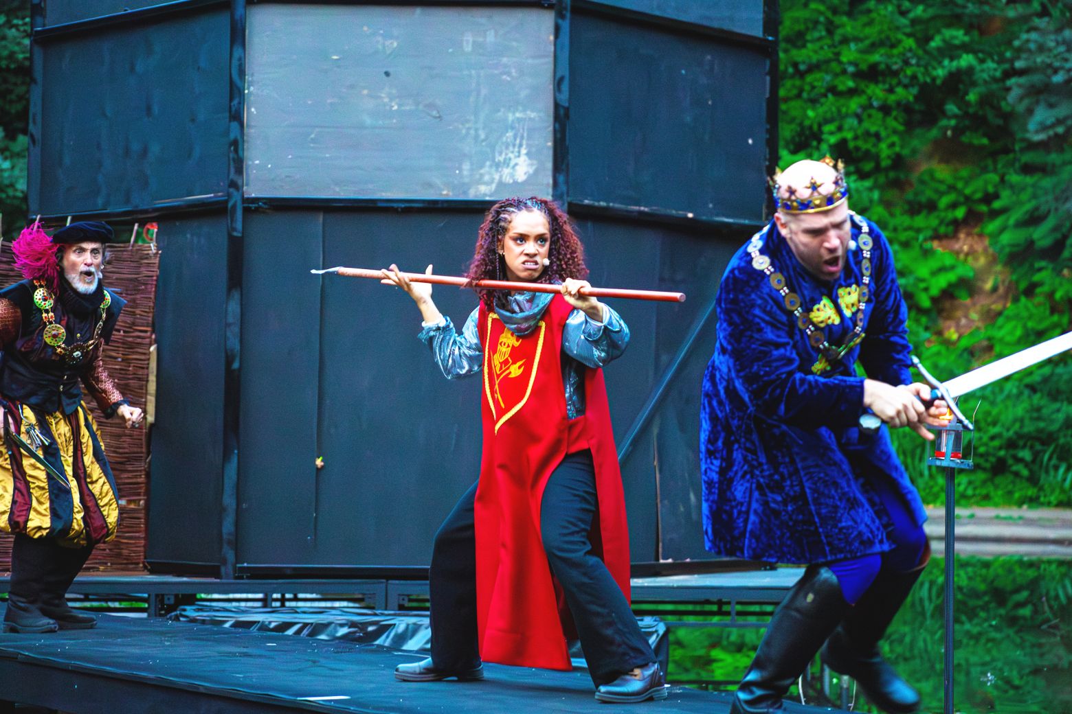 Ian Crowe's Sheriff, Hope Yolanda's Marian, and Matthew Ganley's King Richard have a fight on a platform on the lake.