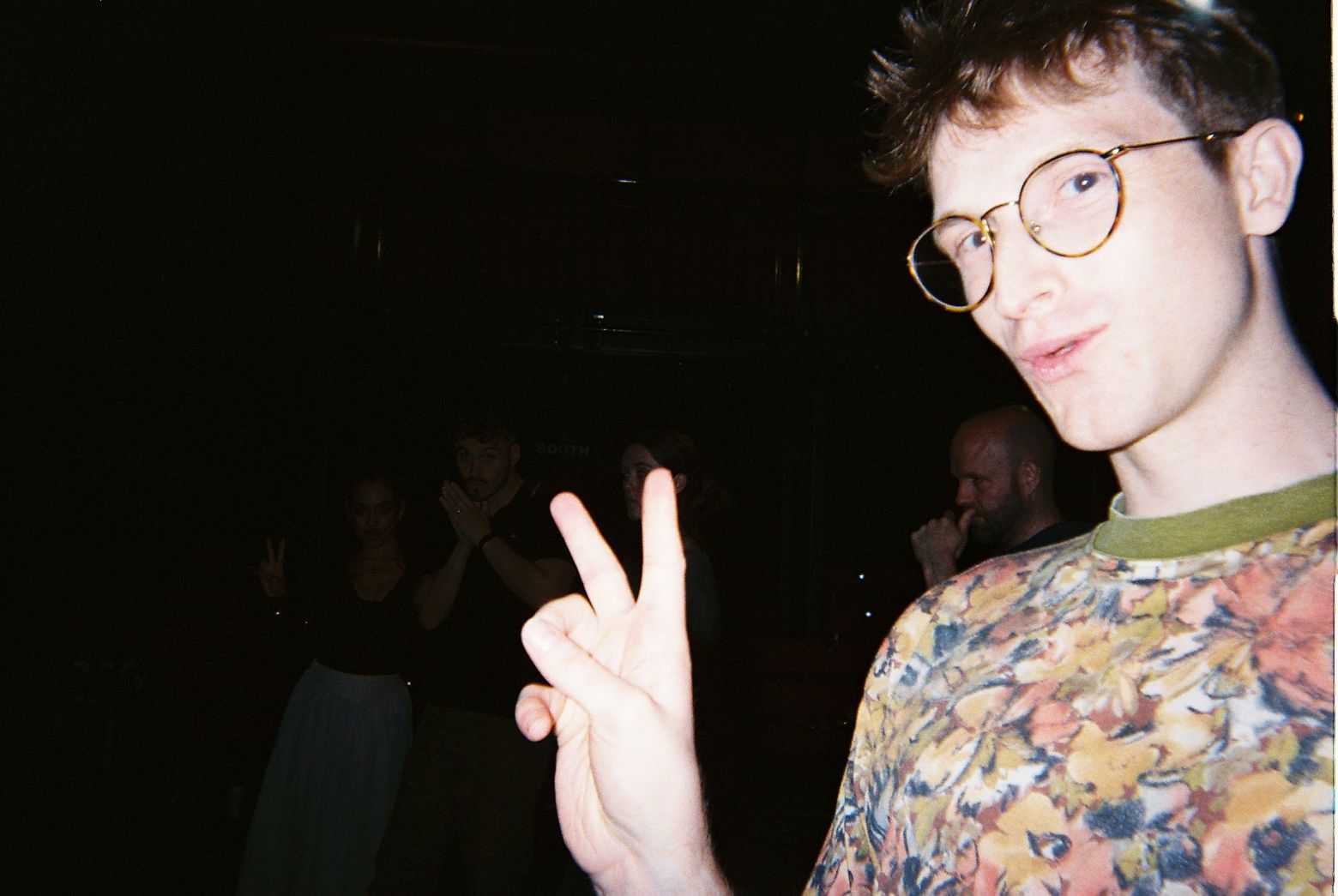 One of our songwriters Bay Bryan posing with the cast in the background