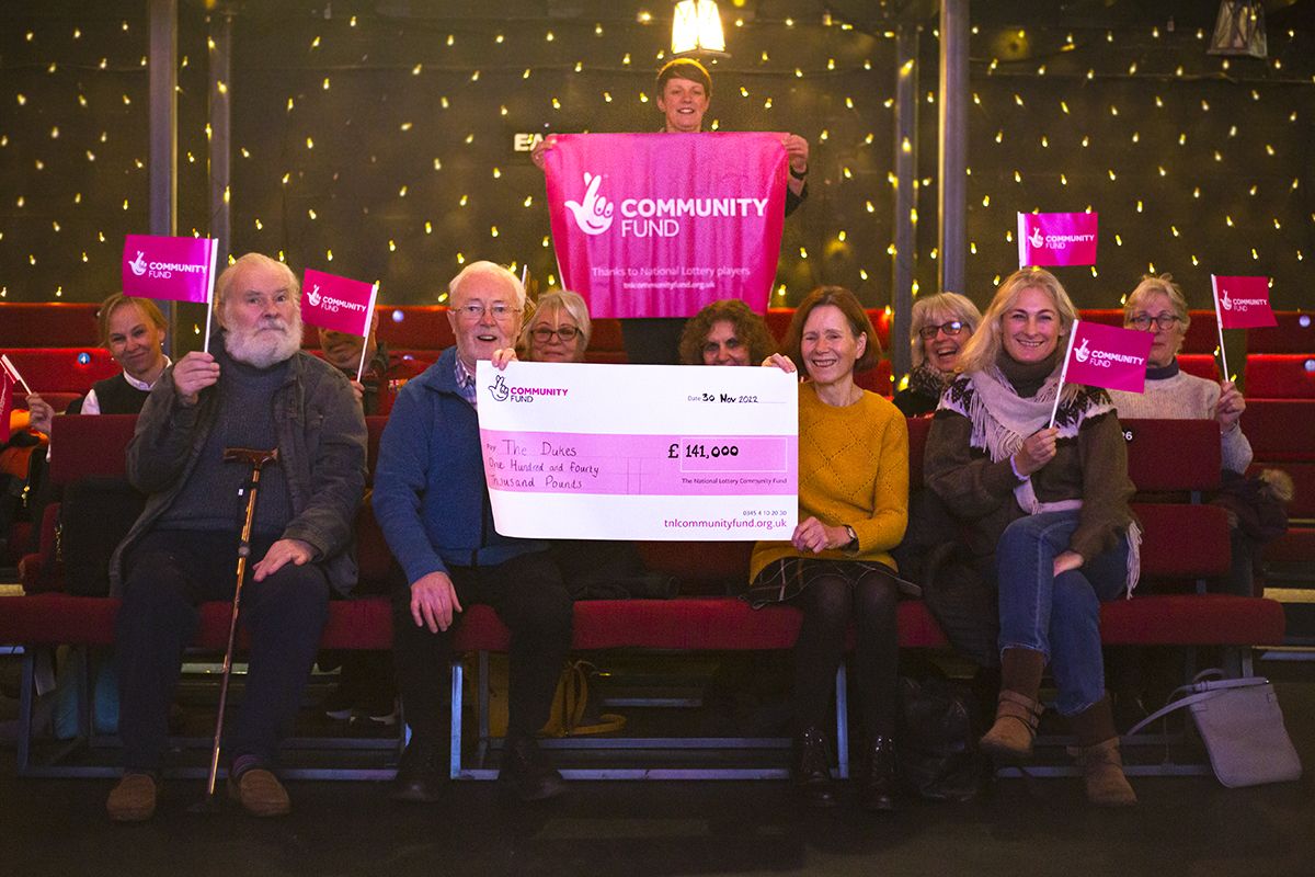 Our prime time group showcasing their cheque from the national lottery
